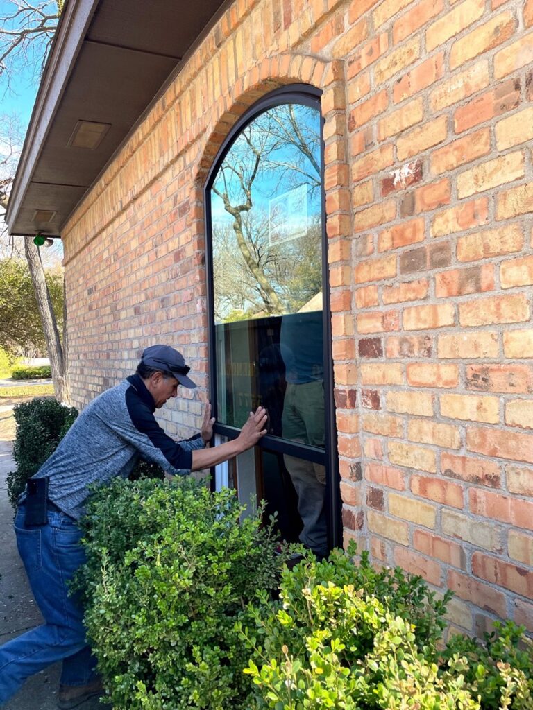 A-man-installing-energy-efficient-picture-replacement-windows-in-Kendall-FL